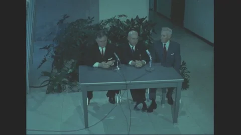 View of Mr. Webb, Dr. Robert R. Gilruth and Bob Casey seated at a table - 1964 Stock Footage 101918876