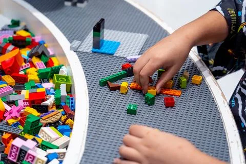 View on multi color plastic bricks at the table. Stock Photos
