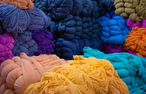 View of the multi-colored thread yarns used in textile industry Stock Photos