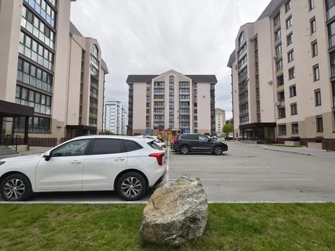 View of a multi-storey building to courtyard with a playground and parking .. Stock Photos
