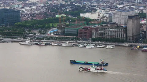 View of multiple barges sailing along river through Shanghai. Shanghai,  China Stock Footage 39098967