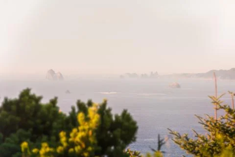 View of multiple Islets that stand out in the Pacific Ocean amid the haze in Stock Photos