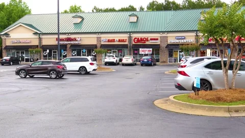 View of multiple retail outlet stores in a shopping center plaza Stock Footage 143511934