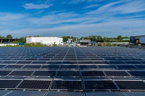 View of multiple solar panels in an industrial area. Stock Photos