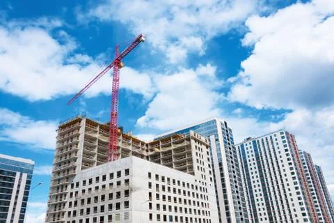 View of a multistorey building under construction with high construction cran Fotos Stock