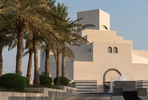 View of Museum of Islamic Art in Doha Qatar from the side with palm trees  Photos