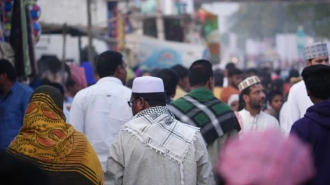 View of Muslim people wearing cap walking on road Stock Footage 147706853