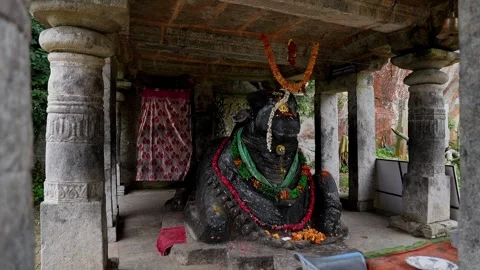 View of Nandi statue decorated with flowers at a sacred worshiping place Stock Footage 339650026