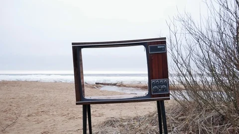 View of nature through a broken TV. sandy beach at the Bay in winter Video stock 123370406