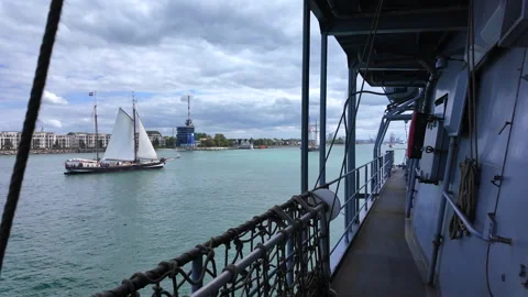 View from naval frigate deck looking at sailing schooner during Hanse Sail. Stock Footage 342041938