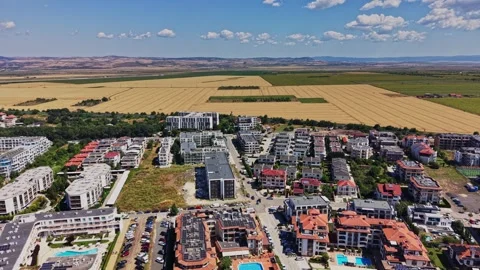 A view of a neighborhood with fields and mountains in the background Stock-Footage 339652336