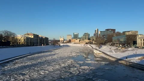 View of Neris river and Vilnius city center from bridge on sunny frosty day Stock Footage 260885711