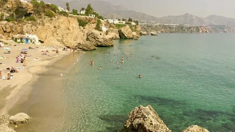 View of the Nerja beach with sunbeds and sunshades Stock Footage 238457289