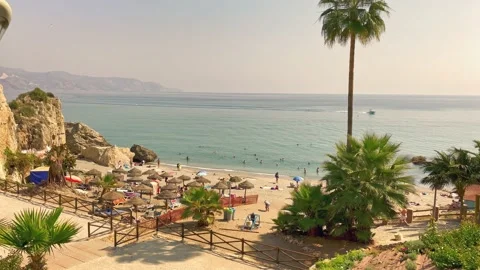 View of the Nerja beach with sunbeds and sunshades Stock Footage 238701210