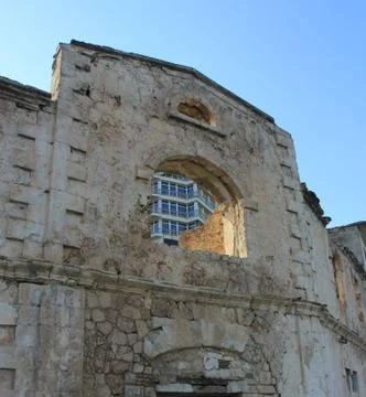 View of a new building through the window of an old house Stock Photos