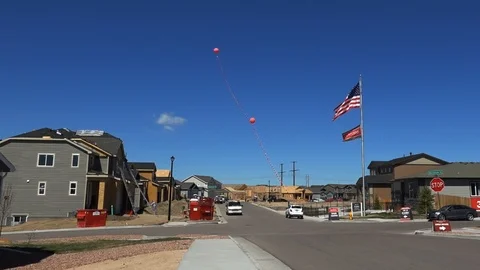 View of New Homes being Built with Flags and Balloons 4K Video stock 107100398