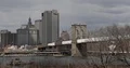 View of New York City with Brooklyn Bridge Transport Ship Passing on East River 4k or 4k+ Resolution