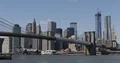 View of New York City Lower Manhattan Brooklyn Bridge and Ferry Boat Passing Day 4k or 4k+ Resolution