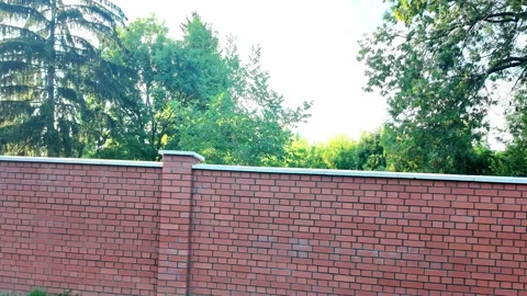 View of the newly completed red brick wall. New brick wall made of red bricks Stock Footage 318149381