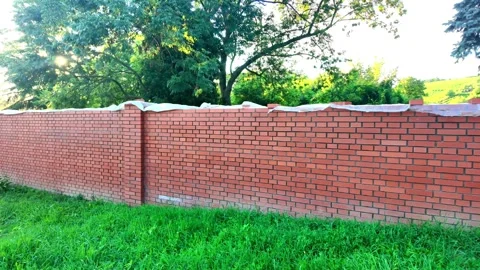View of the newly completed red brick wall. New brick wall made of red bricks Stock Footage 318189866