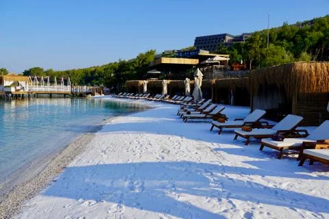 View of nice empty sandy beach with some tropical bungalow. Banner, lots of copy Фото