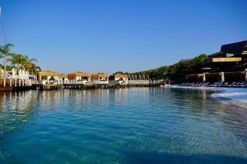 View of nice empty sandy beach with some tropical bungalow. Banner, lots of copy Фото
