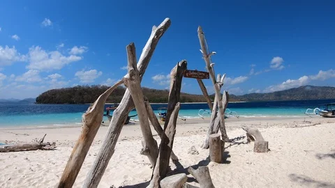View of nice tropical empty sandy beach with boats and clear blue water Stock Footage 113940711