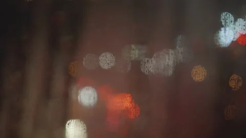 View of night city lights through window, outdor defocuses, raindrops on glass Stock Footage 236623439