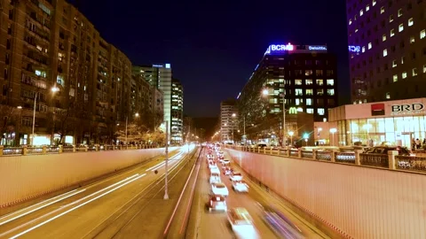 View of night traffic light trails and office buildings in Bucharest, Romania. Stock Footage 335601170