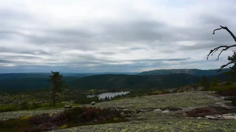 View of norwegan landscape with low clouds and a lake in the distance durin.. Stock Footage 340210291