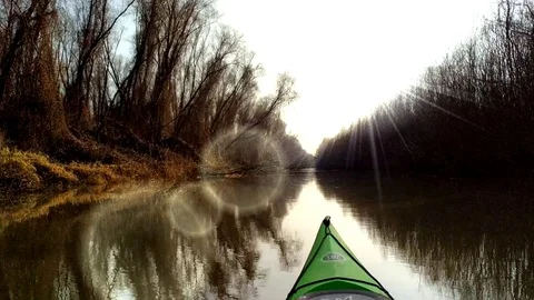 View from the nose (bow,prow) of kayak on trees at shoreline Stock Footage 104564784