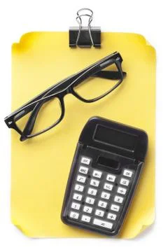 View of note with spectacles and calculator Stock Photos