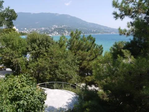 View of the observation deck between the trees and the resort coast with deve Stock Photos