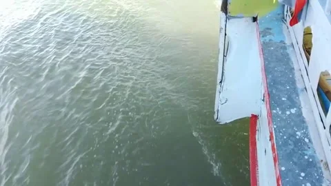 A view of the ocean from a boat moving through the water on sunny day. 스톡 동영상 346617536