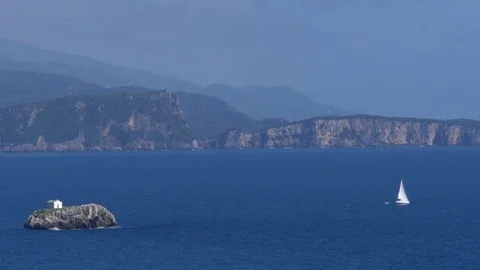 View of ocean coastline with steep slopes floating islands and boats Stock Footage 78221716
