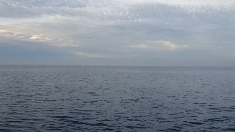 View of ocean currents and waves with a background of sky and clouds Stock Footage 297016809