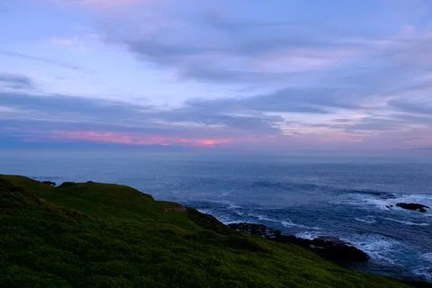 View of the ocean an horizon blue and pink sky Stock Photos