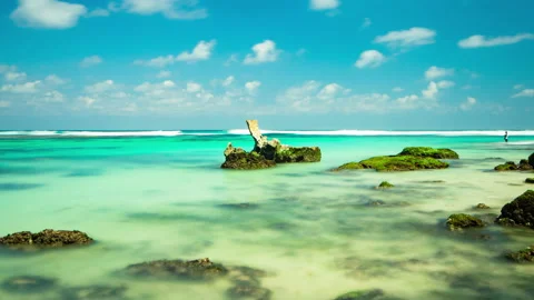 View on ocean with piece of cliff and clear blue water. 4K. Time lapse. Stock Footage 115276380