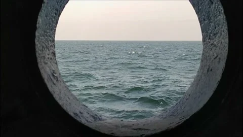 View of the ocean from the porthole of the ship going 스톡 동영상 138595033