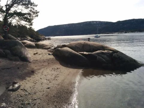 View of the ocean with rocks and a small beach Stock Photos