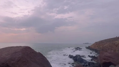 View of ocean with stony coast in evening Stock Footage 84891758