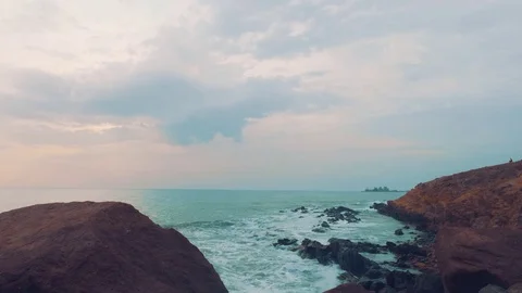 View of ocean with stony coast in evening Stock Footage 84892159