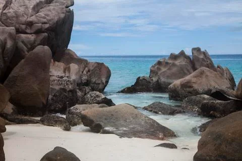 View onto the ocean surrounded by boulders Stock Photos