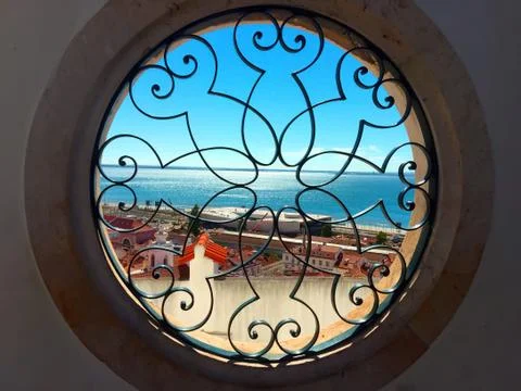 View to the ocean through the round window Stock Photos