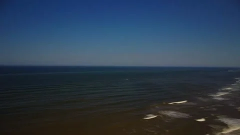 View of ocean waves and clear sky at the beach during midday with no people.. Stock Footage 339939323