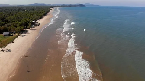 View of ocean waves crashing on beach with people walking by on beautiful beach. Stock Footage 102426297