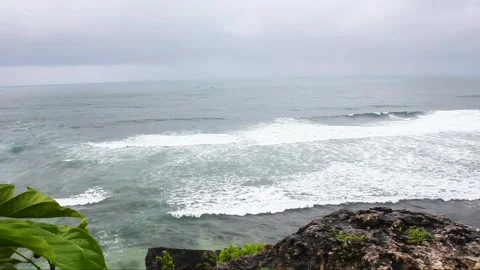 View of ocean waves crashing onto the beach from the top of the cliff Stock Footage 297769587