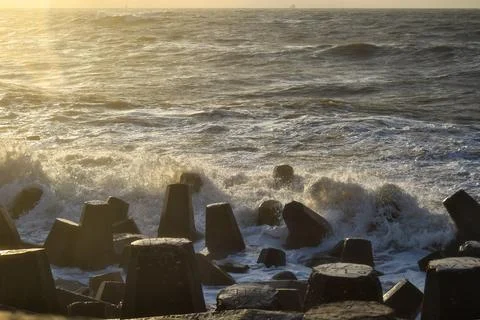 A view of the ocean waves intercepted by a wave breaker  Stock Photos