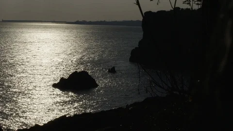 VIEW OF OCEAN WAVES AT NIGHT WITH ROCKS AND MOONLIGHT Video stock 127424065