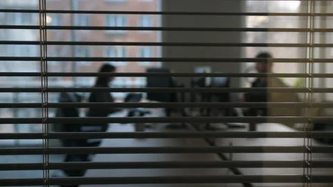 View of the office office through the partially opened blinds 스톡 동영상 171572923